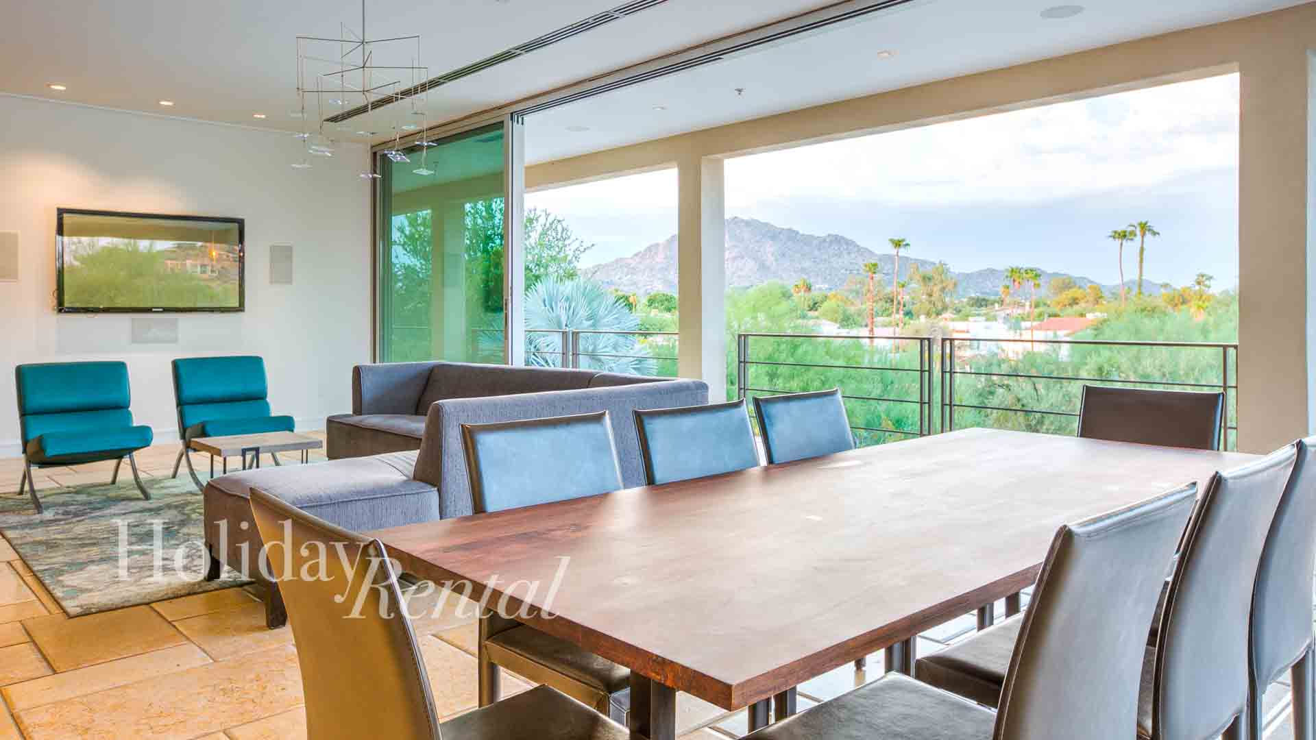 luxury vacation rental living space and dining area with mountain views