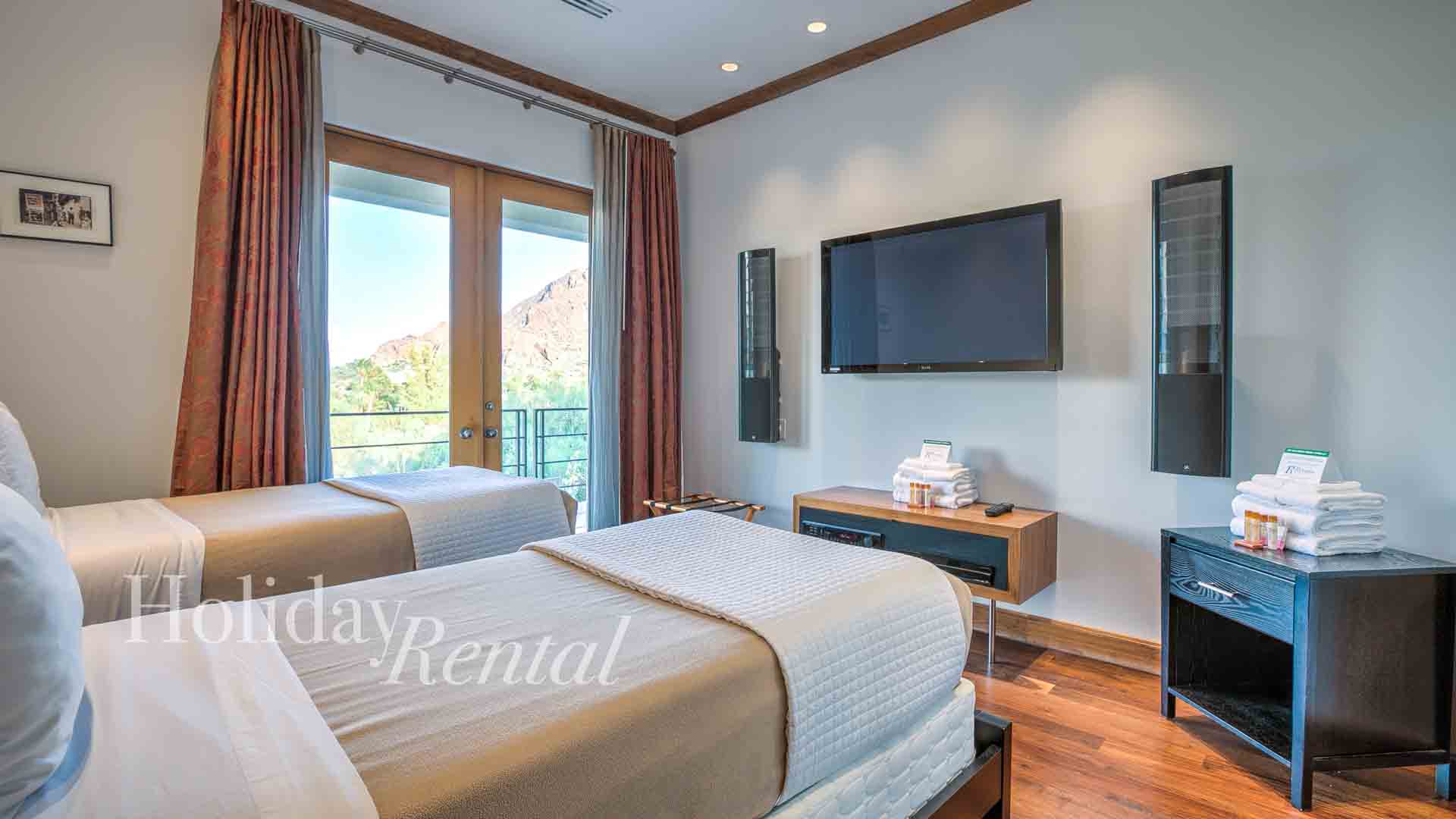 vacation rental bedroom with tv and mountain views