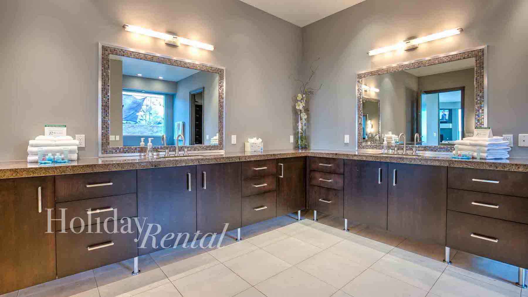 vacation rental bathroom with his and her vanities