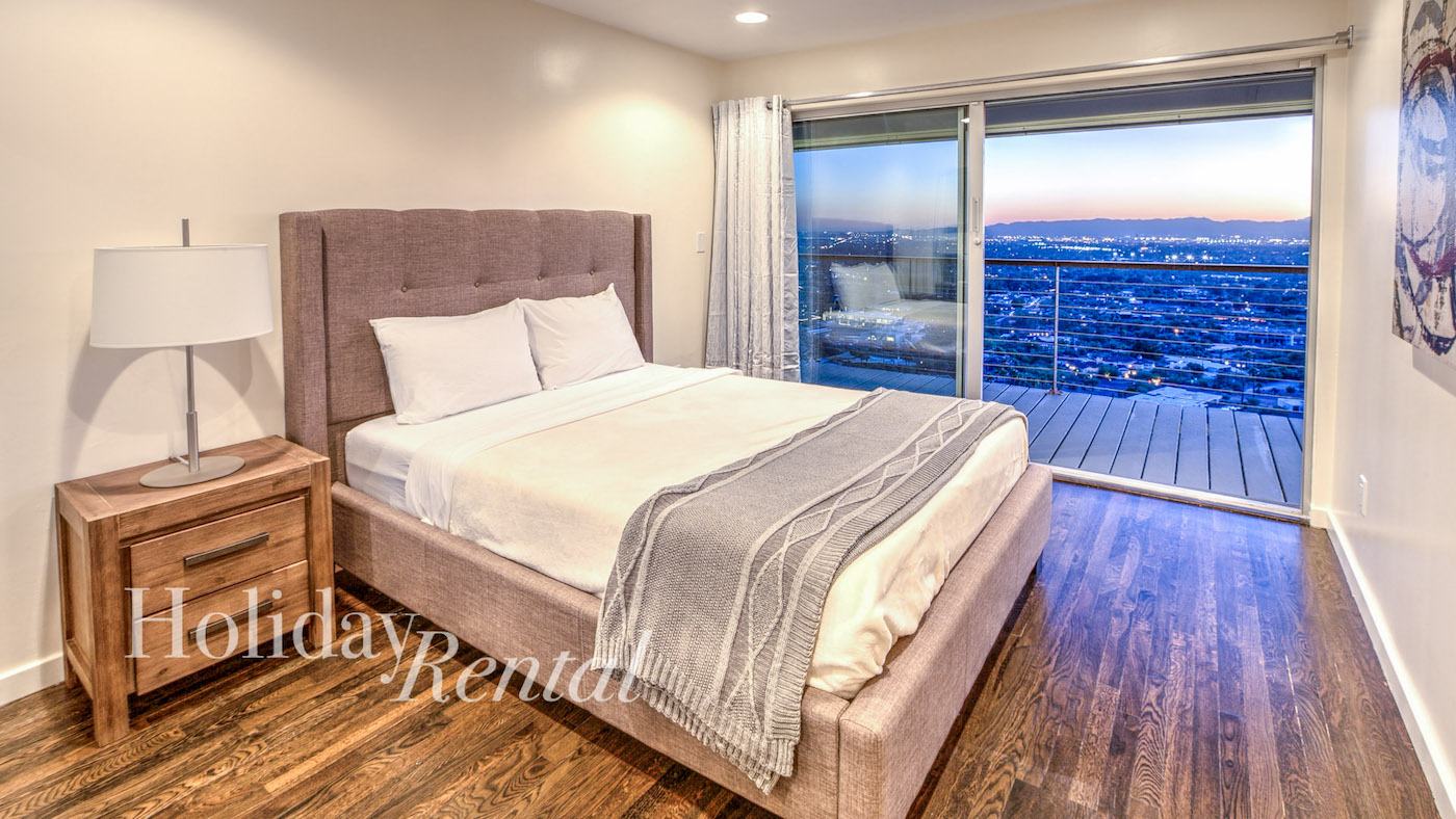 luxury vacation rental bedroom with access to the deck