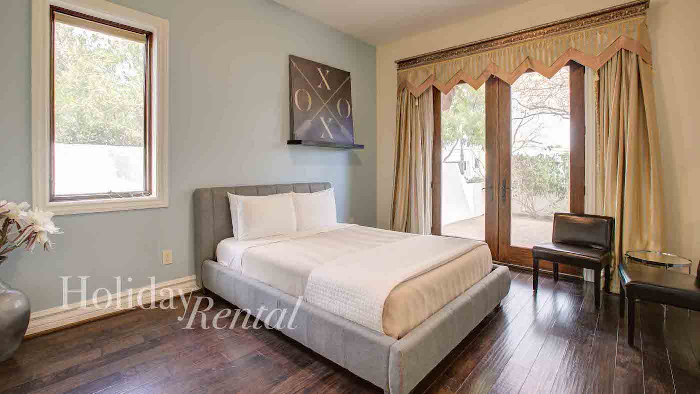 vacation rental bedroom with backyard access