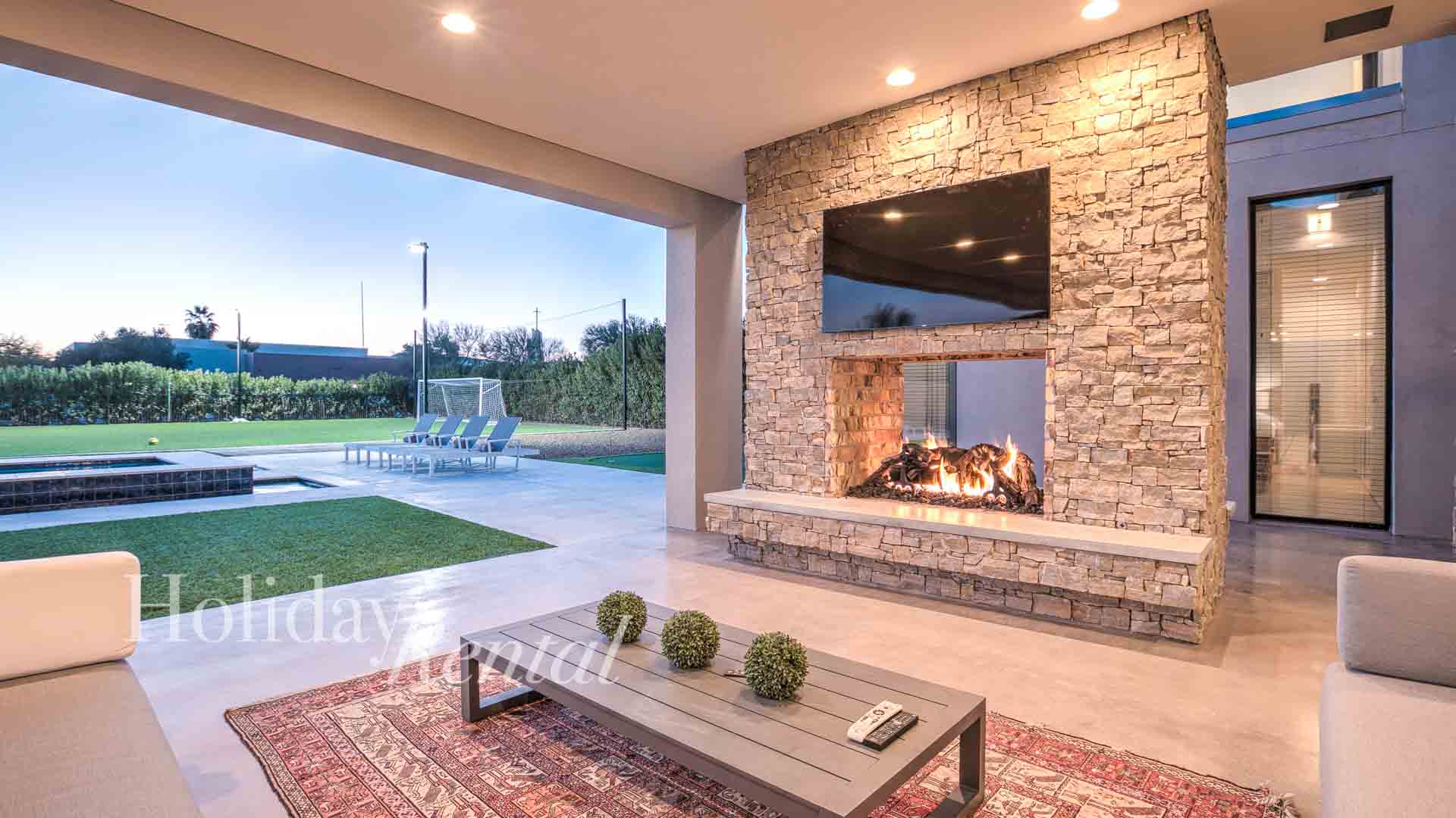 vacation rental patio with tv and fireplace