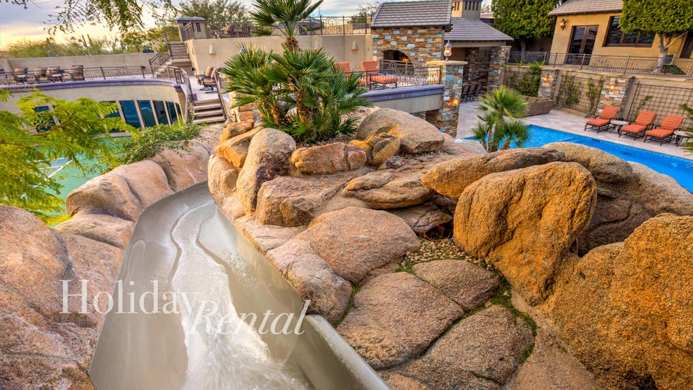vacation rental with waterslide into pool