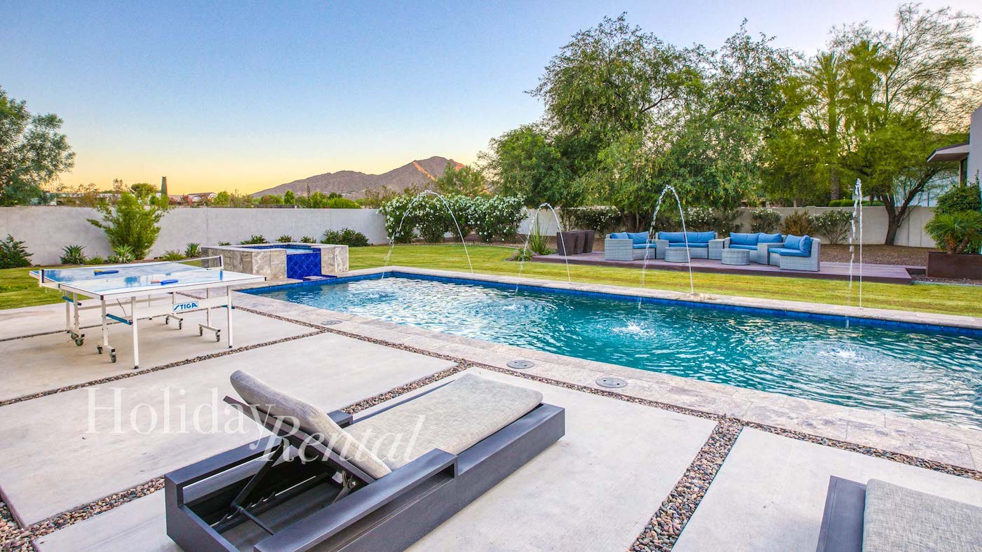 vacation rental with poolside loungers
